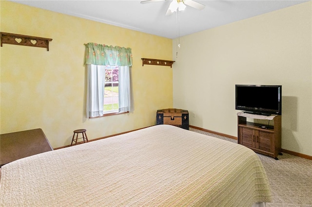 carpeted bedroom with a ceiling fan and baseboards