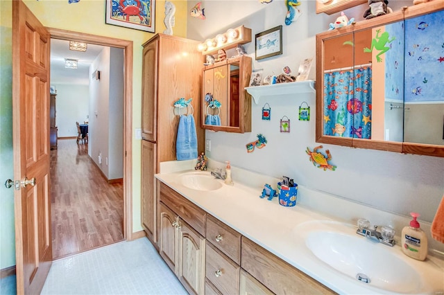 full bath featuring double vanity and a sink