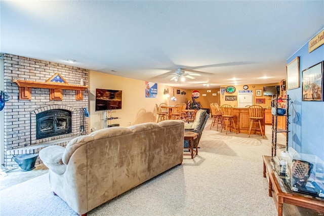living area featuring a ceiling fan, a dry bar, light colored carpet, and a fireplace