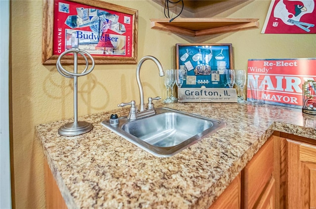 interior space featuring a textured wall and a sink