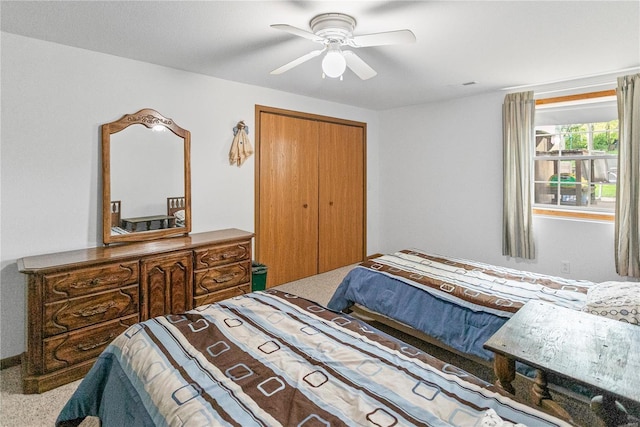 bedroom featuring ceiling fan, carpet flooring, and a closet