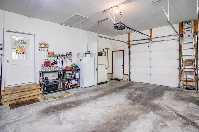 garage with freestanding refrigerator and a garage door opener