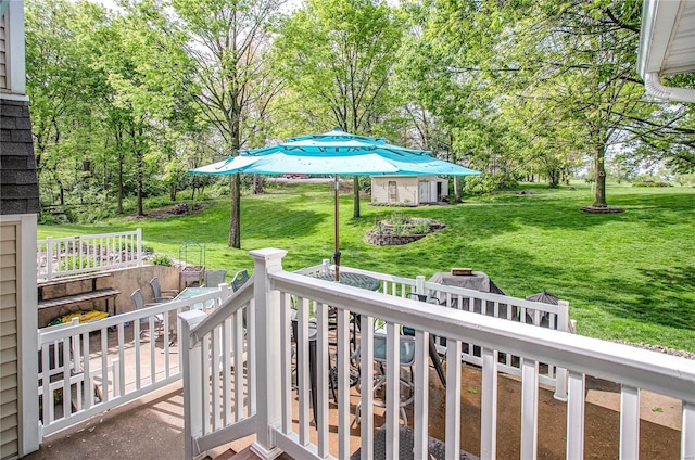 exterior space featuring an outbuilding, a deck, and a fire pit