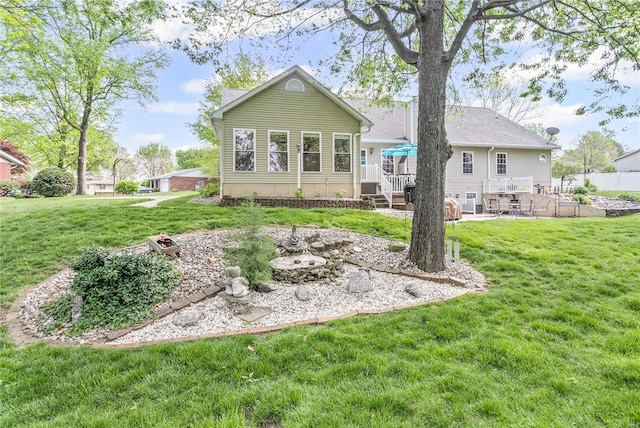 rear view of house with fence, a yard, and a patio area