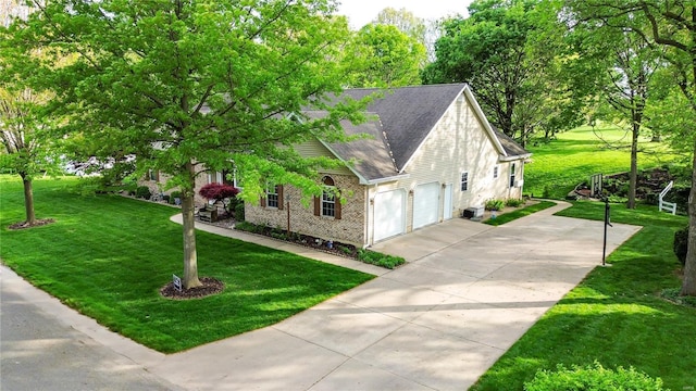 view of side of property with brick siding, a shingled roof, driveway, and a lawn