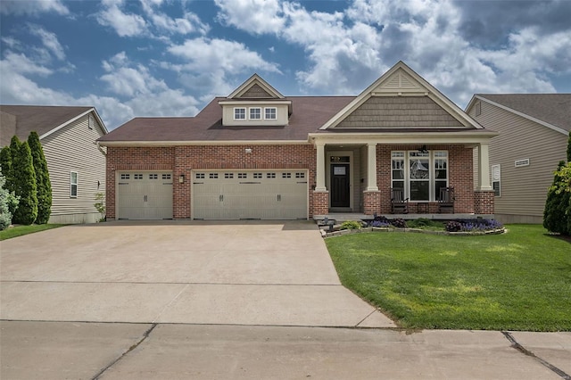 craftsman-style house featuring concrete driveway, brick siding, an attached garage, and a front yard