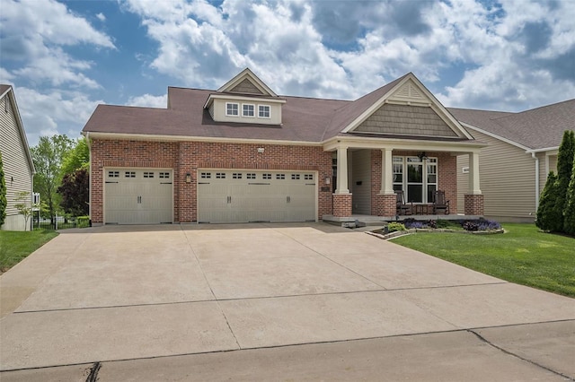 craftsman-style house with an attached garage, a front lawn, brick siding, a porch, and concrete driveway