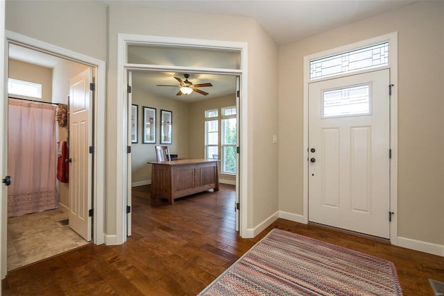 entryway with baseboards, dark wood-style floors, and ceiling fan