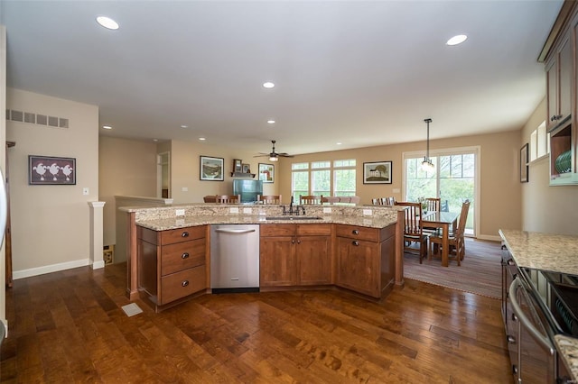kitchen with a sink, stainless steel dishwasher, dark wood-type flooring, and visible vents