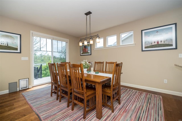 dining room featuring baseboards and dark wood-style floors