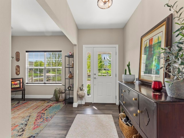 entryway with baseboards and dark wood-style floors
