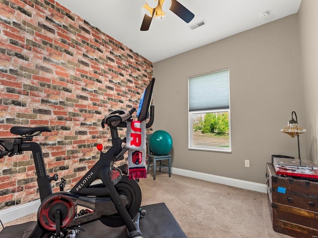 workout area with carpet floors, ceiling fan, visible vents, and baseboards