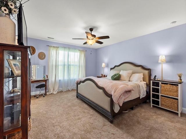 bedroom with a ceiling fan, baseboards, light colored carpet, and visible vents