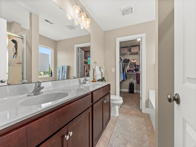 full bathroom with visible vents, a sink, a stall shower, and double vanity