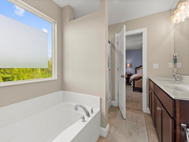 full bathroom with a garden tub, double vanity, a stall shower, a sink, and ensuite bath