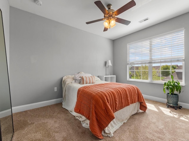 bedroom featuring carpet flooring, a ceiling fan, baseboards, and visible vents