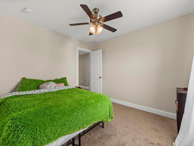 carpeted bedroom with baseboards, ceiling fan, and visible vents
