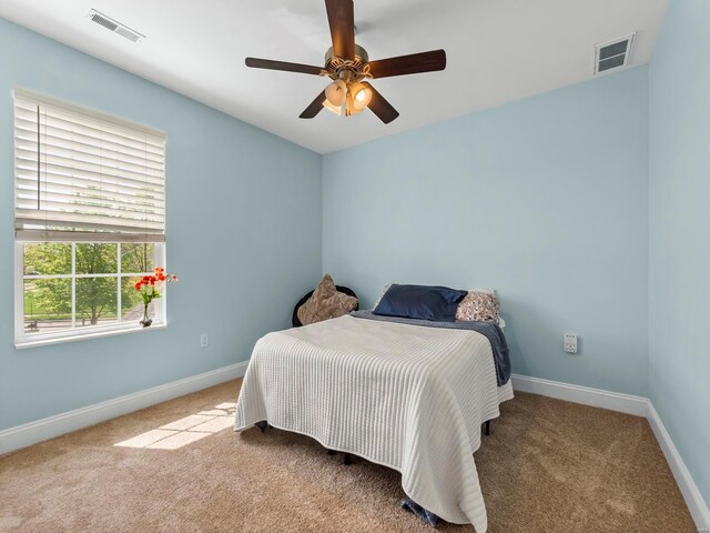 bedroom with carpet floors, baseboards, and visible vents