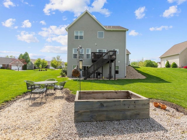 rear view of house featuring a lawn, stairs, a garden, and a wooden deck