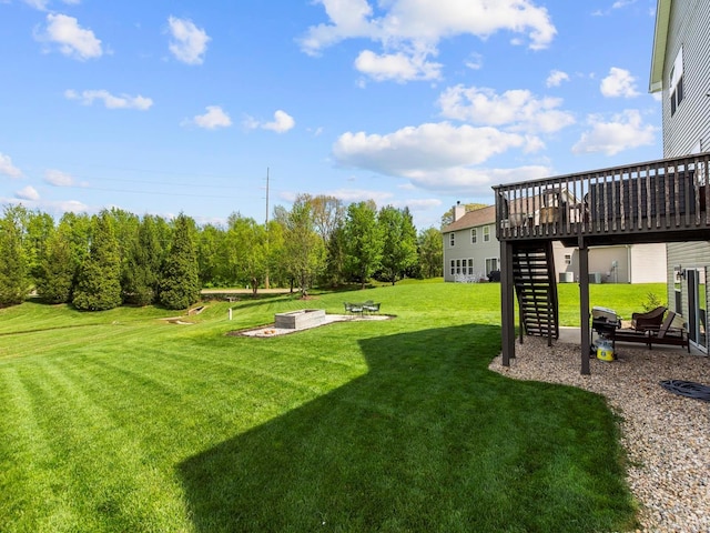 view of yard featuring stairway, a patio, and a wooden deck
