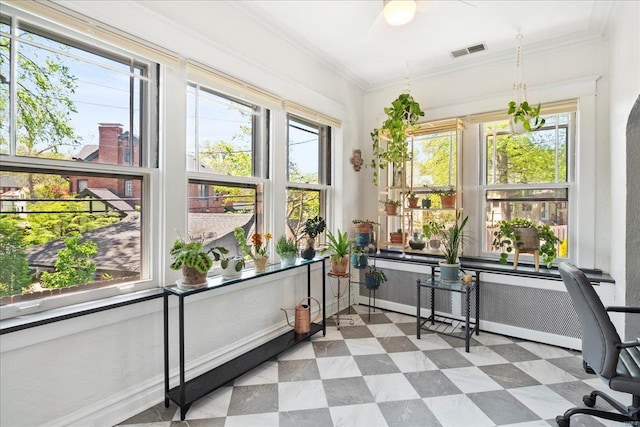 unfurnished sunroom featuring crown molding, visible vents, radiator heating unit, and plenty of natural light