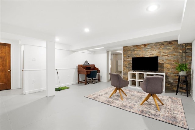 living area with finished concrete flooring, recessed lighting, and baseboards