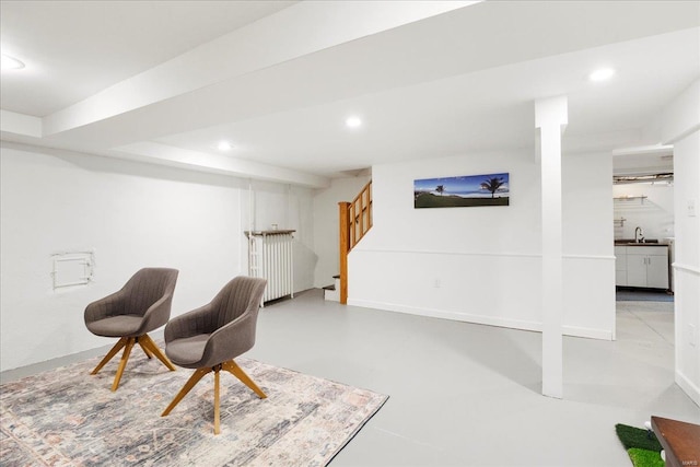 living area featuring baseboards, recessed lighting, concrete flooring, and stairs