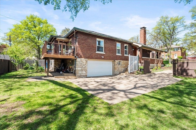 rear view of house featuring fence, a chimney, stairs, and a garage