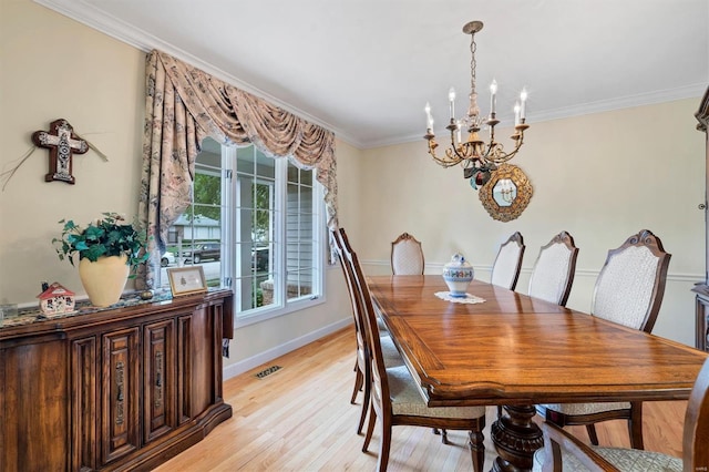 dining room with an inviting chandelier, crown molding, visible vents, baseboards, and light wood-style flooring