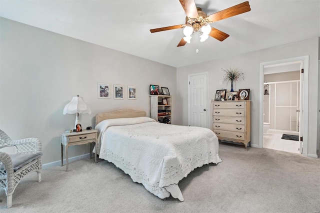 carpeted bedroom with baseboards, a ceiling fan, and ensuite bathroom