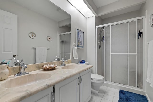 bathroom with a sink, tile patterned floors, a stall shower, and double vanity