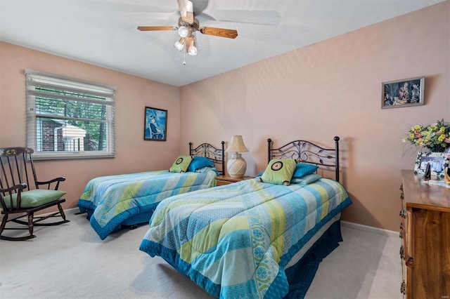 carpeted bedroom featuring a ceiling fan and baseboards