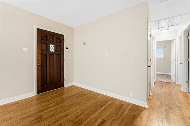 entryway with baseboards and light wood-style flooring