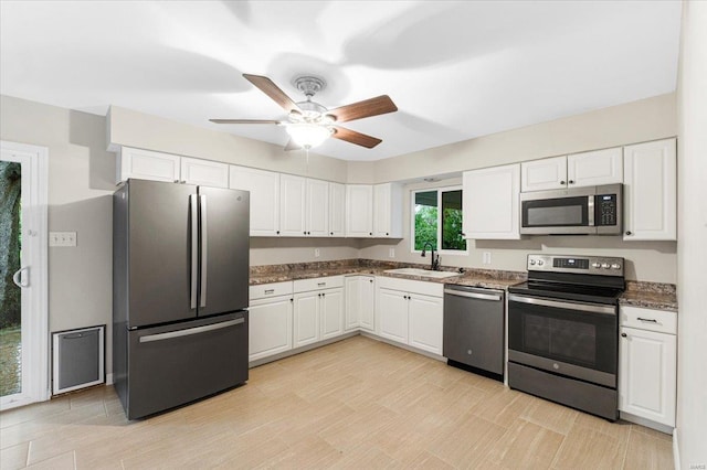 kitchen with white cabinets, stainless steel appliances, and a sink