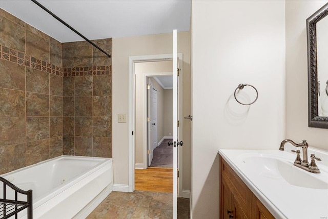 full bath with baseboards and vanity