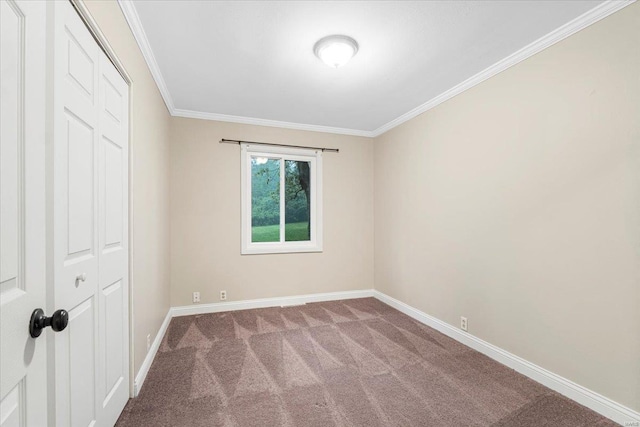 unfurnished bedroom featuring crown molding, baseboards, carpet, and a closet
