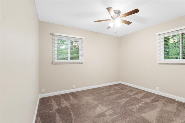 empty room with carpet flooring, ceiling fan, plenty of natural light, and baseboards