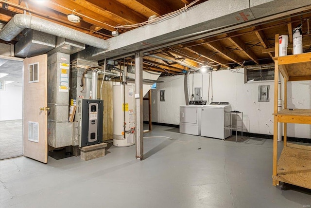 unfinished below grade area featuring visible vents, heating unit, independent washer and dryer, and gas water heater