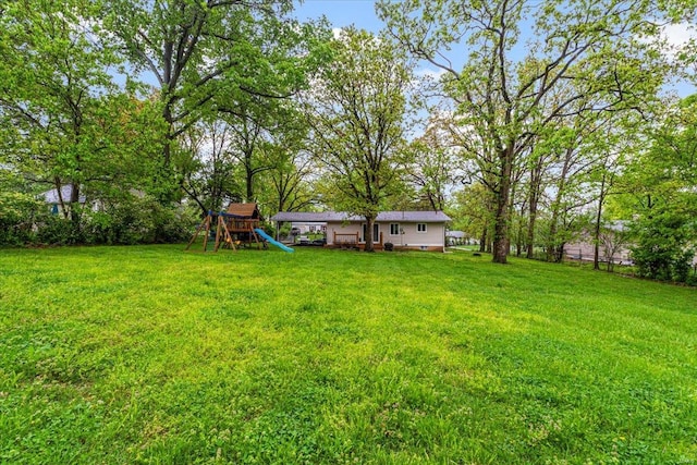 view of yard featuring a playground and fence