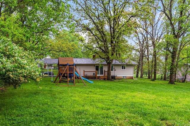 rear view of house with a playground and a lawn