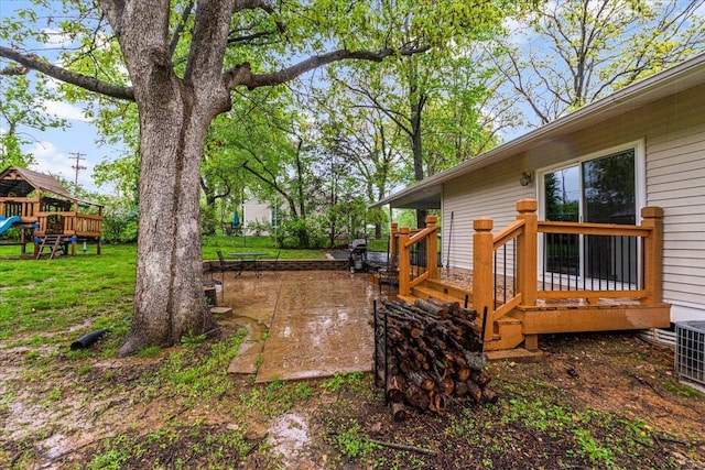 view of yard featuring a playground and central AC