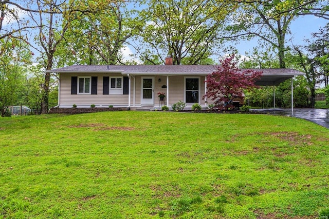 ranch-style house with a chimney, fence, aphalt driveway, a front lawn, and an attached carport