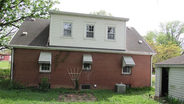 rear view of house featuring brick siding and central air condition unit