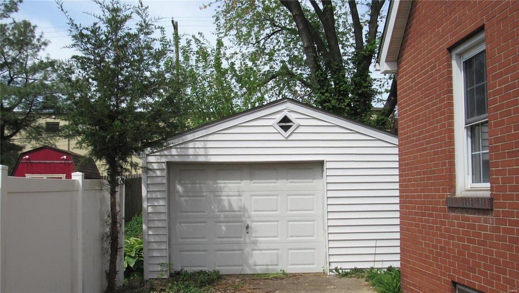 detached garage featuring fence