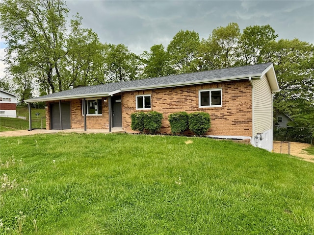 single story home with a front yard, a garage, brick siding, fence, and concrete driveway