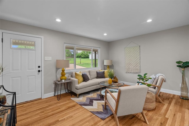 living room featuring baseboards, recessed lighting, and light wood-type flooring
