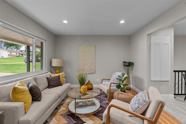 living area featuring baseboards and recessed lighting