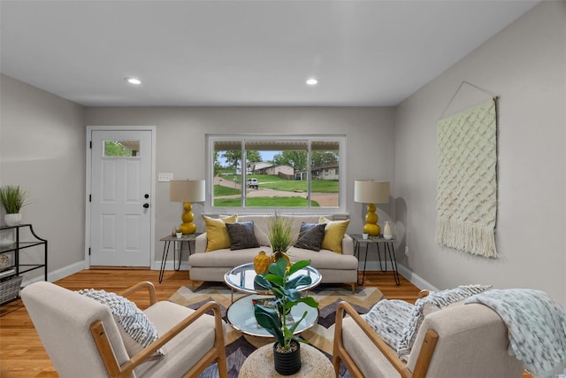 living room with recessed lighting, a healthy amount of sunlight, and wood finished floors