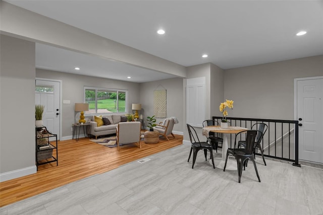 dining room featuring baseboards, recessed lighting, and wood finished floors