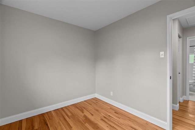 unfurnished room featuring baseboards and light wood finished floors